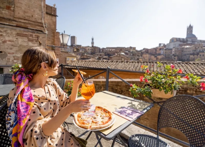 Woman eating pizza while on a vacation in Europe Woman eating pizza while on a vacation in Europe